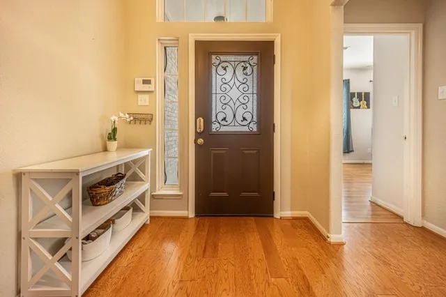 a view of an entryway with wooden floor
