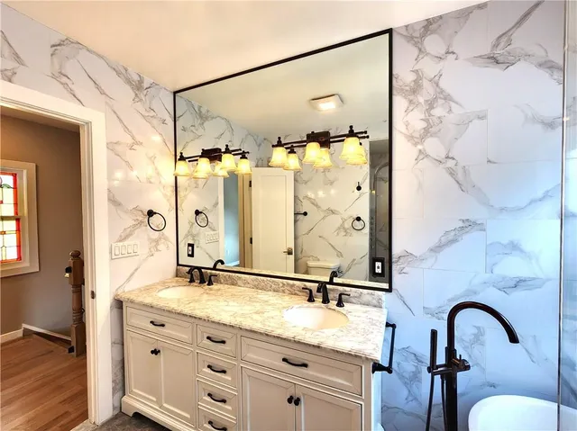 a bathroom with a white tub sink and shower