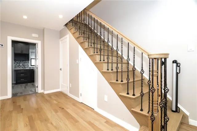 a view of entryway and hall with wooden floor