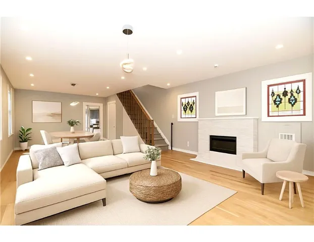 a living room with furniture and a book shelf