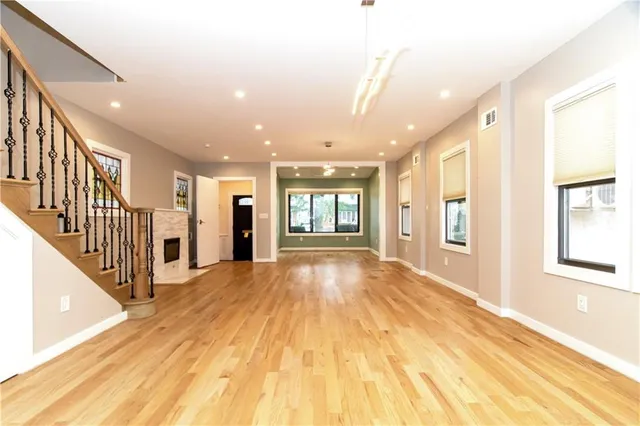 a kitchen with stainless steel appliances a sink cabinets and a window