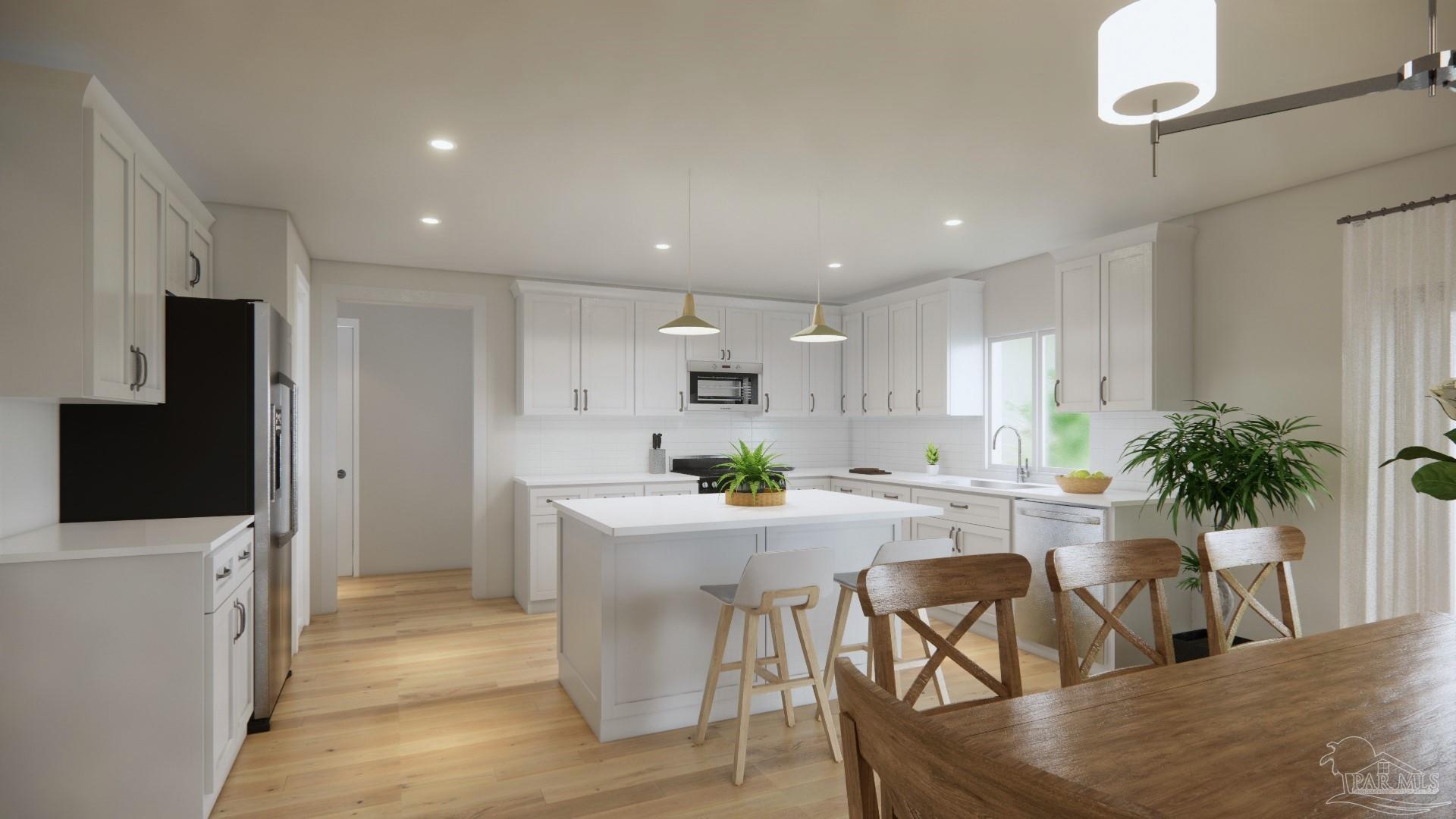 4388 Russell Elliott Road, Unit 37 Jay, FL 32565 - Photo 8 of 18 a kitchen with white cabinets and stainless steel appliances