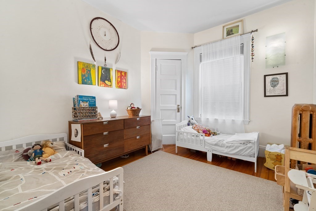 70 Montebello Road, Unit 1 Boston, MA 02130 - Photo 11 of 20 a bedroom with furniture and a bed