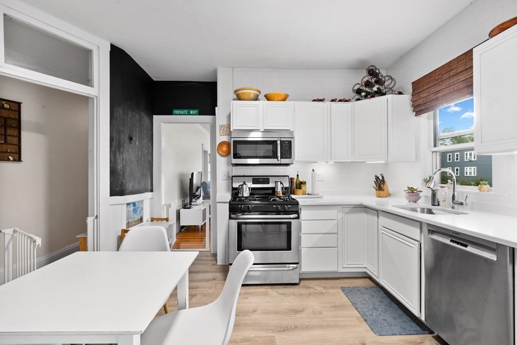 70 Montebello Road, Unit 1 Boston, MA 02130 - Photo 2 of 20 a kitchen with a sink stainless steel appliances and cabinets