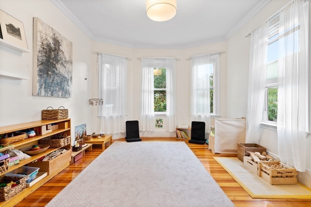 70 Montebello Road, Unit 1 Boston, MA 02130 - Photo 5 of 20 a bedroom with furniture and a large window