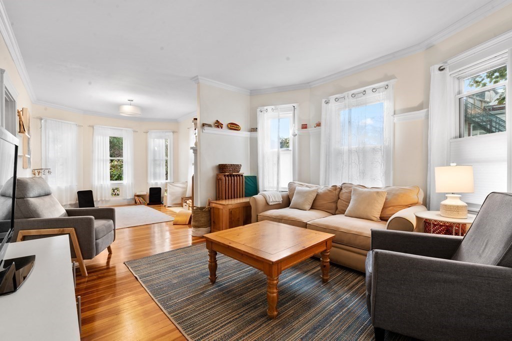 70 Montebello Road, Unit 1 Boston, MA 02130 - Photo 6 of 20 a living room with furniture wooden floor and a table