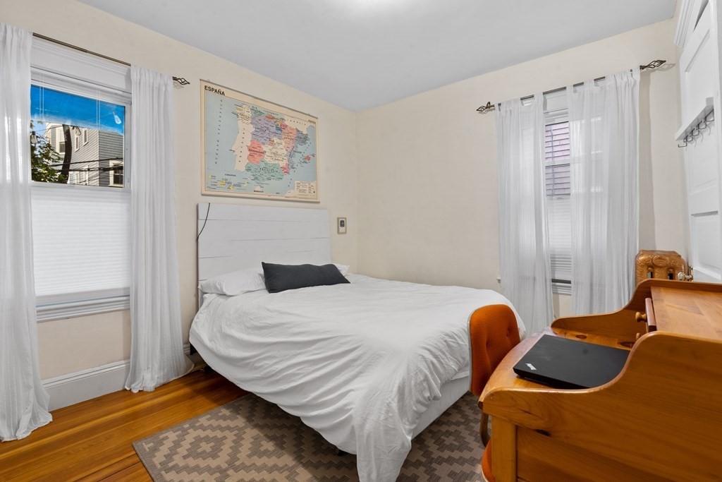 70 Montebello Road, Unit 1 Boston, MA 02130 - Photo 9 of 20 a bedroom with a bed and wooden floor