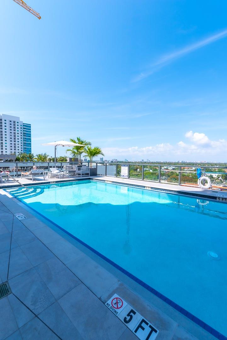 a view of a room with rug and window
