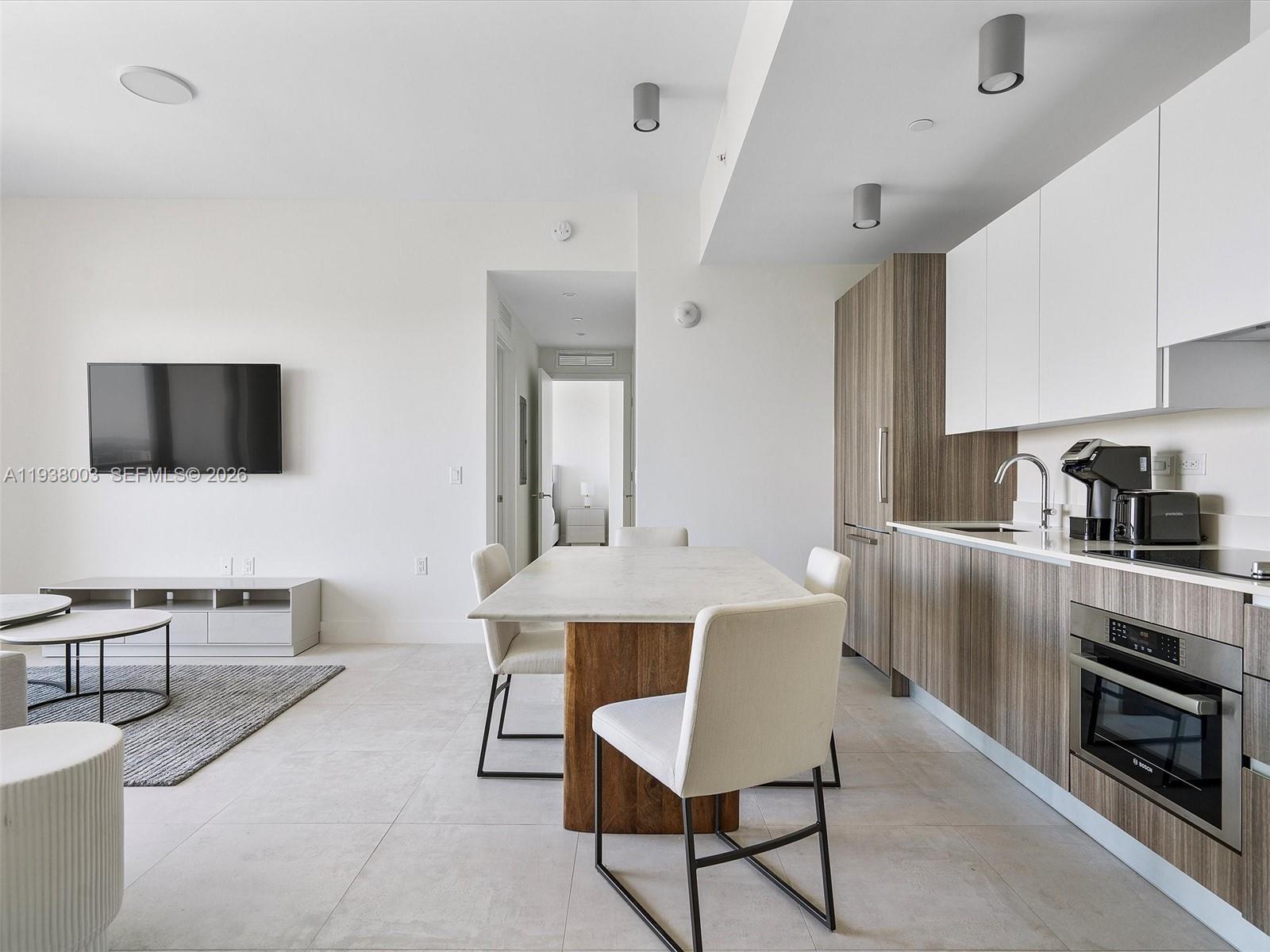239 Southwest 9th Street, Unit 2003 Miami, FL 33130 - Photo 14 of 52 a living room with furniture and a flat screen tv