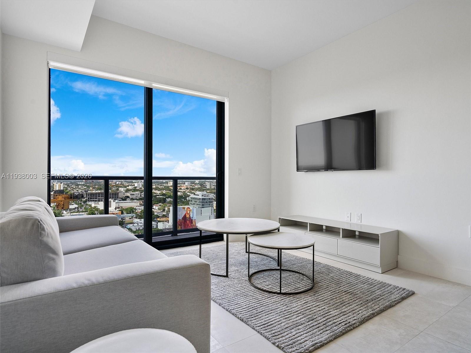 239 Southwest 9th Street, Unit 2003 Miami, FL 33130 - Photo 16 of 52 a living room with furniture rug and a flat screen tv