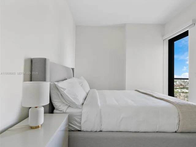 a bedroom with a bed and a lamp