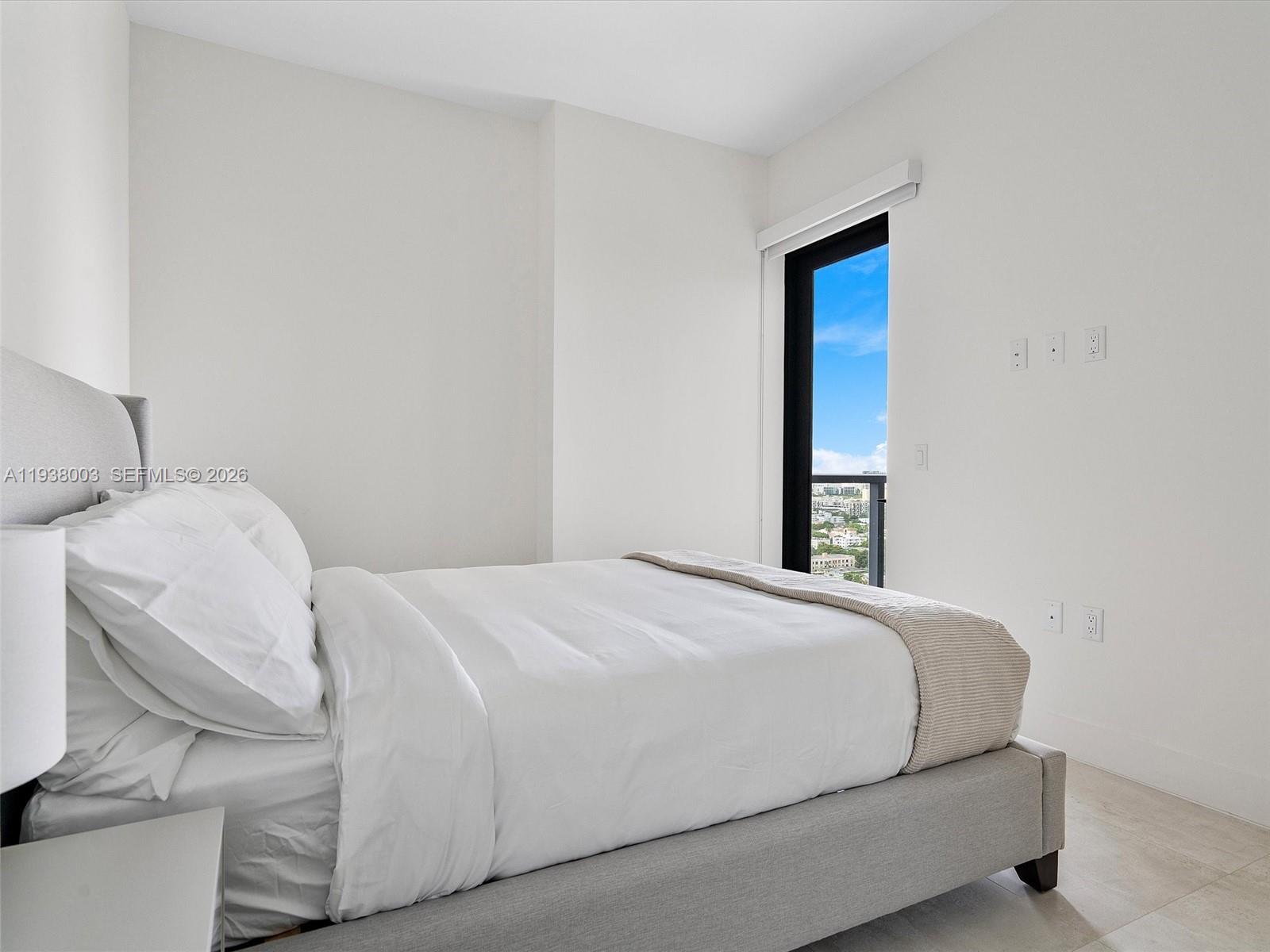 239 Southwest 9th Street, Unit 2003 Miami, FL 33130 - Photo 32 of 52 a bedroom with a bed and a window