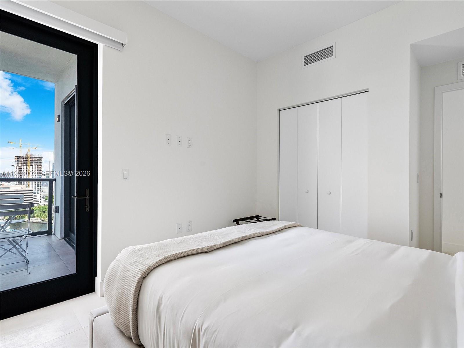 239 Southwest 9th Street, Unit 2003 Miami, FL 33130 - Photo 34 of 52 a bedroom with a bed and a window