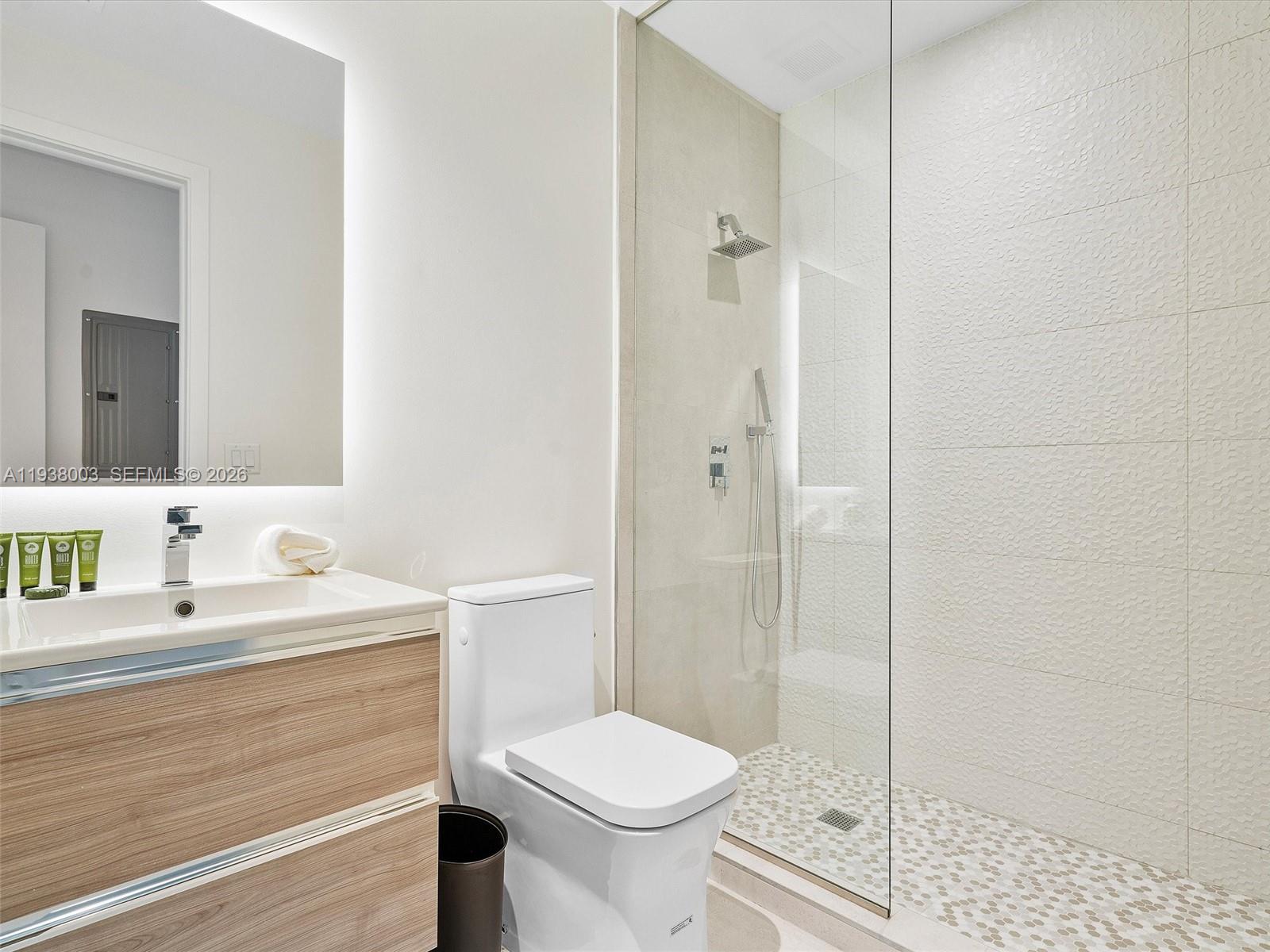 239 Southwest 9th Street, Unit 2003 Miami, FL 33130 - Photo 35 of 52 a bathroom with a sink toilet and shower