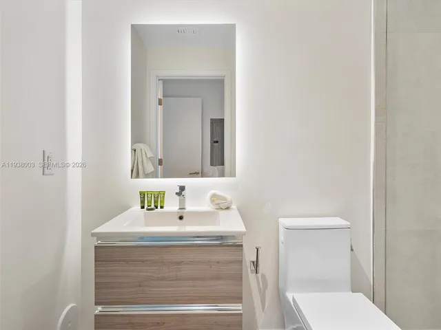 a large bed sitting in a bedroom next to a window