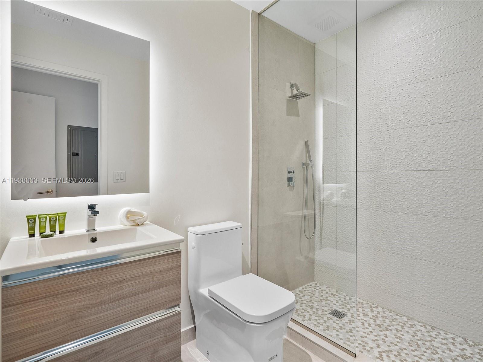 239 Southwest 9th Street, Unit 2003 Miami, FL 33130 - Photo 37 of 52 a bathroom with a sink toilet and shower