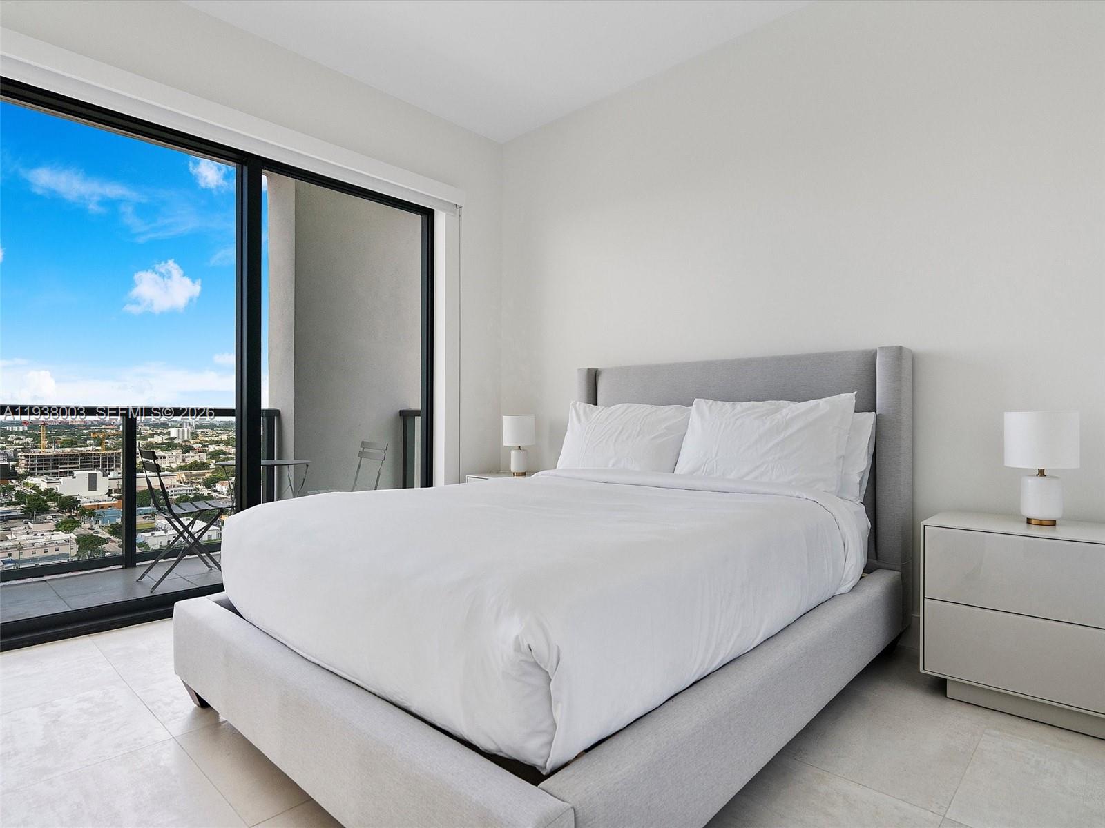 239 Southwest 9th Street, Unit 2003 Miami, FL 33130 - Photo 38 of 52 a large bed sitting in a bedroom next to a window