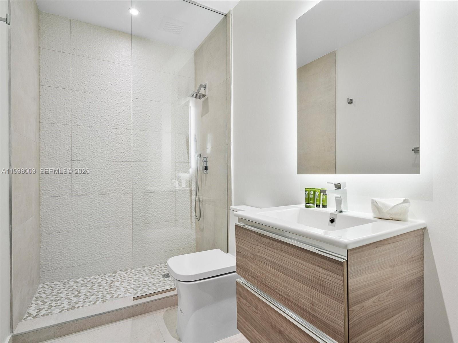 239 Southwest 9th Street, Unit 2003 Miami, FL 33130 - Photo 45 of 52 a bathroom with a sink toilet and shower