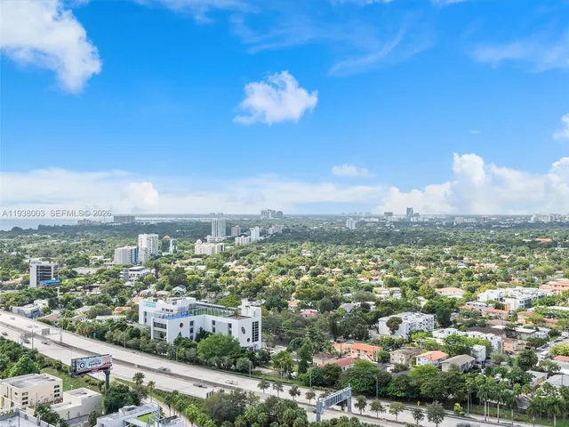 a view of an empty room with large windows