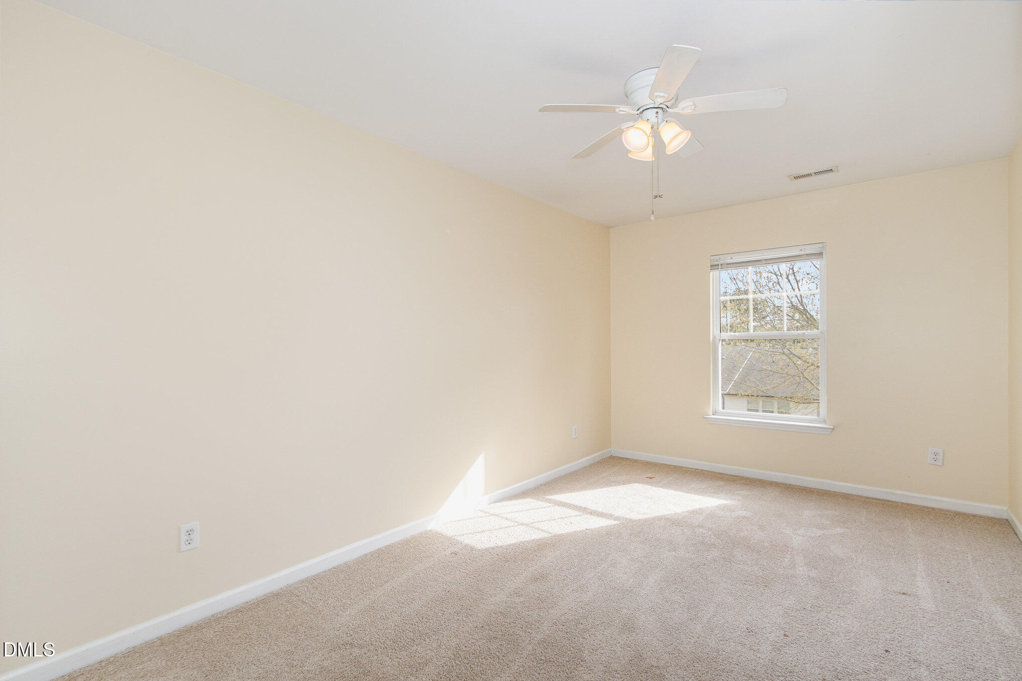 1311 Canyon Rock Court, Unit U105 Raleigh, NC 27610 - Photo 12 of 16 an empty room with a window and a fan
