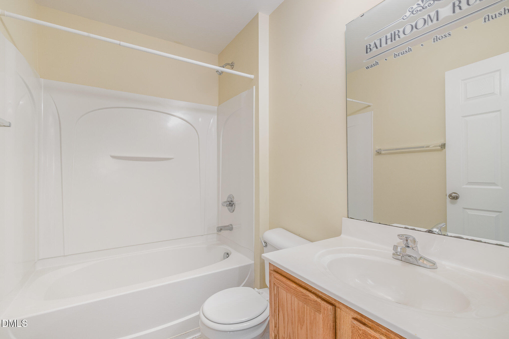 1311 Canyon Rock Court, Unit U105 Raleigh, NC 27610 - Photo 13 of 16 a bathroom with a sink a toilet and a bathtub