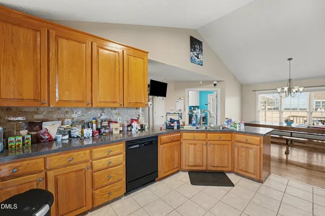 a kitchen with stainless steel appliances a sink counter space and a window