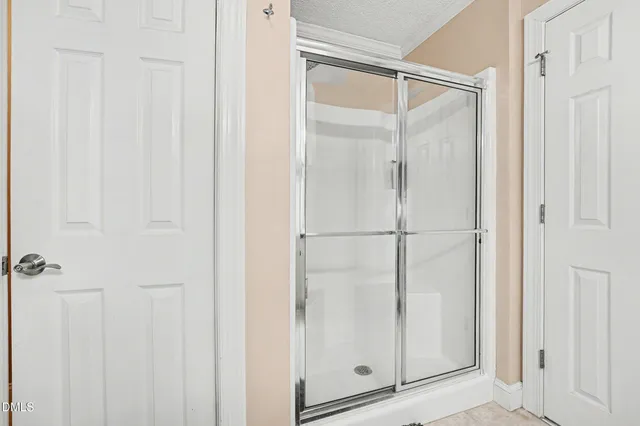 a bathroom with a glass shower door