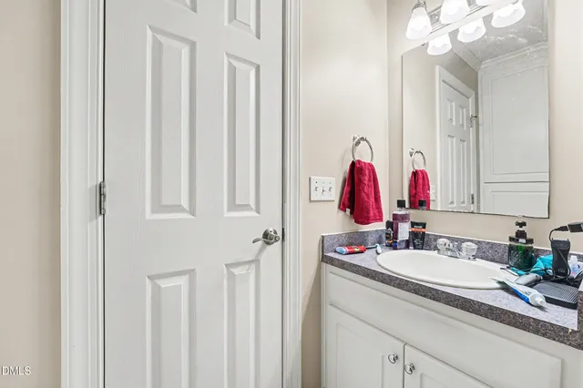 a bathroom with a sink vanity and a mirror