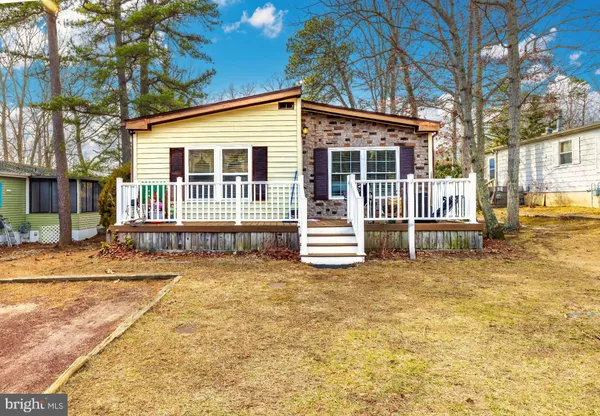 a view of a house with a small yard and wooden fence