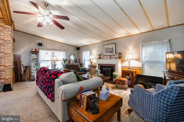 a living room with furniture fireplace and a window