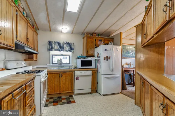 a kitchen with stainless steel appliances granite countertop a stove and a refrigerator