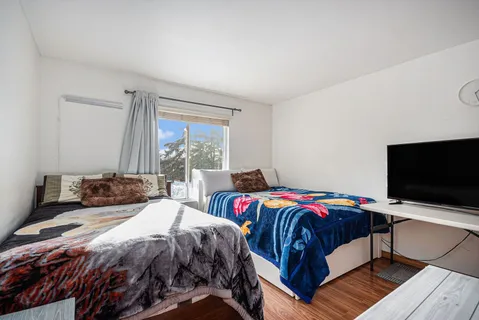 a bedroom with a bed and a flat screen tv