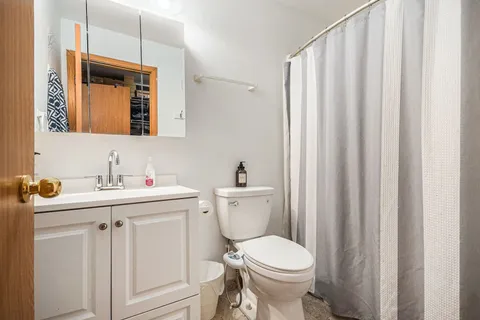 a bathroom with a toilet a sink and a mirror