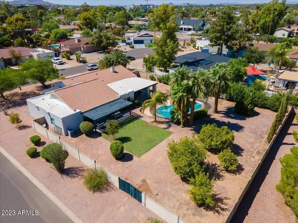 an aerial view of multiple houses with yard