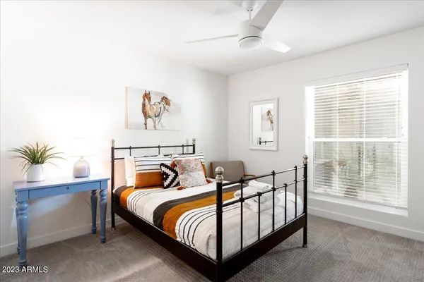 a bedroom with furniture and a window