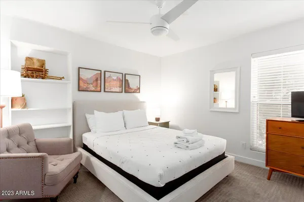 a bedroom with a bed and a couch