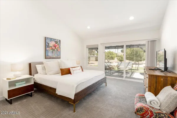 a bedroom with a bed and large window