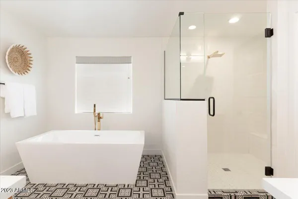 a bathroom with a bathtub and a shower