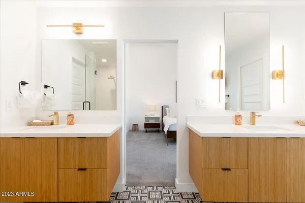 a spacious bathroom with a double vanity sink mirror and