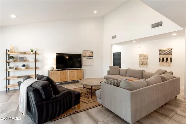 a living room with furniture and a flat screen tv