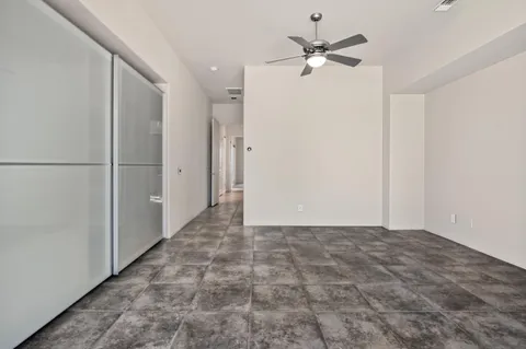 a view of an empty room with a ceiling fan