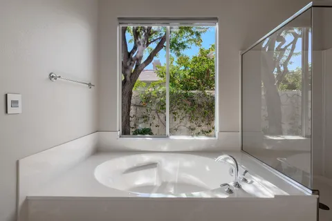 a bath tub sitting in a bathroom next to a window