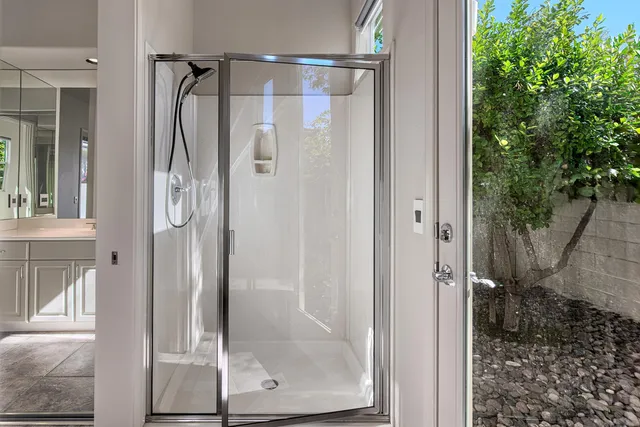 a bathroom with a glass shower door