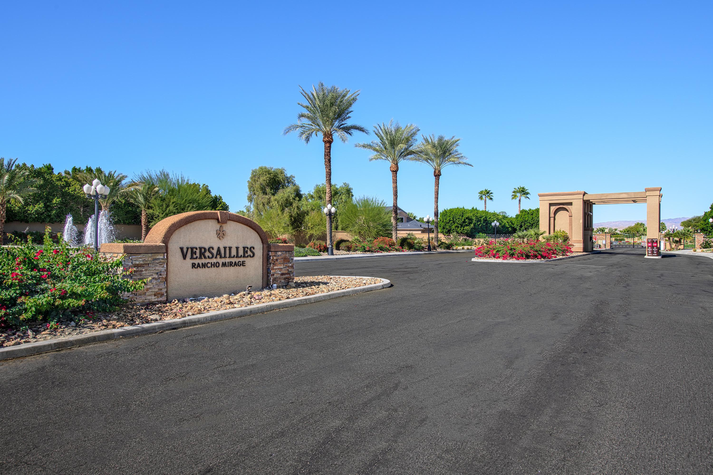 3 Cartier Court Rancho Mirage, CA 92270 - Photo 33 of 33 a view of a street with a building and couple of cars parked in front of it