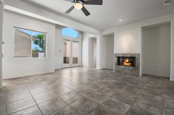 a view of an empty room with a fireplace and a window