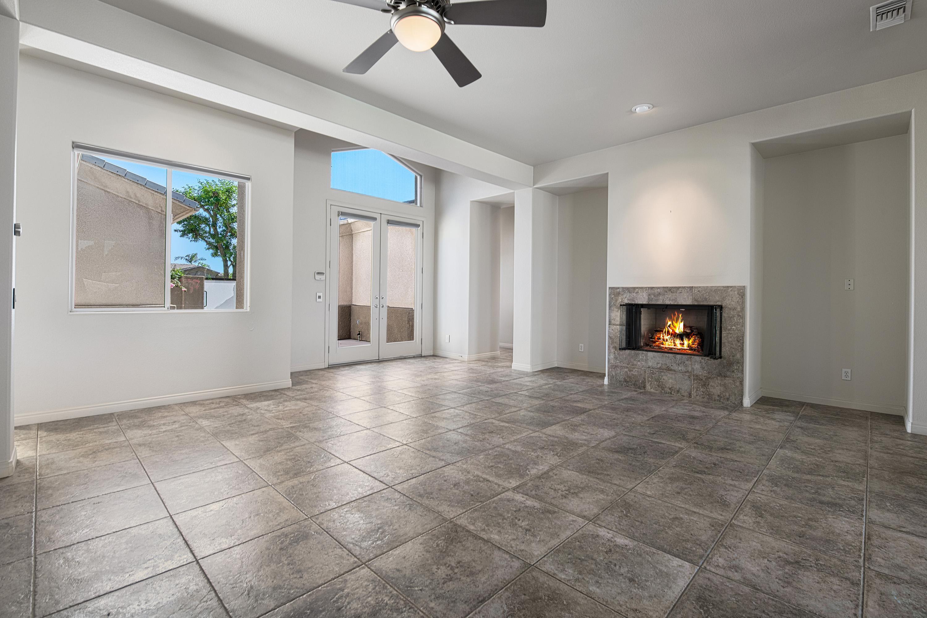 3 Cartier Court Rancho Mirage, CA 92270 - Photo 5 of 33 a view of an empty room with a fireplace and a window