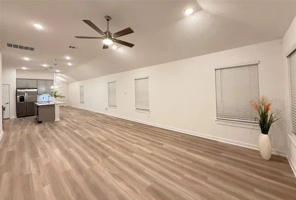 a view of a room with wooden floor