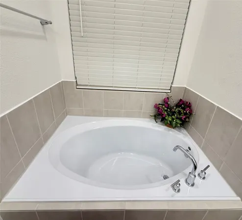 a front view of a house with a garden and plants