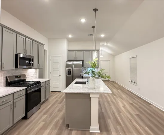 a kitchen with a sink stove and refrigerator