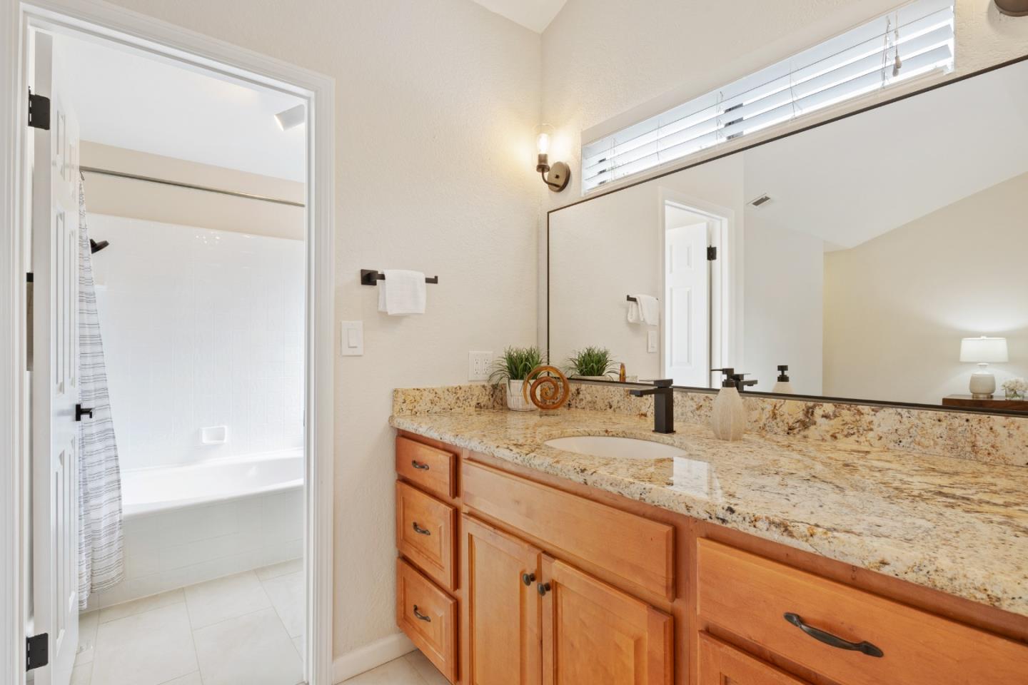 1148 Kayellen Court San Jose, CA 95125 - Photo 17 of 23 a bathroom with a granite countertop sink and a mirror